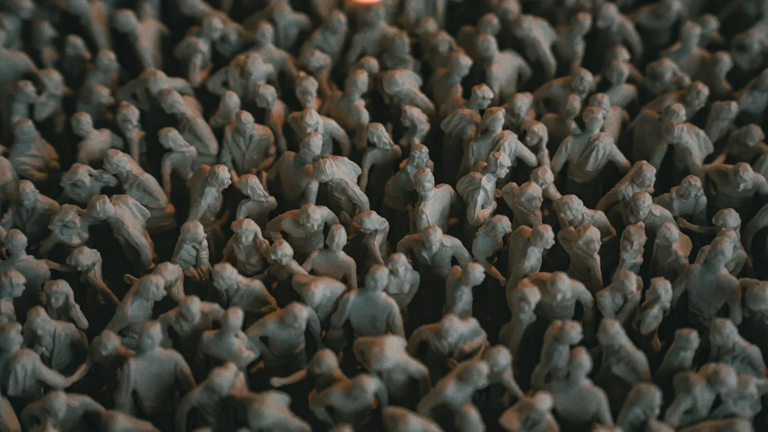 A crowd of small gray human figures packed together.