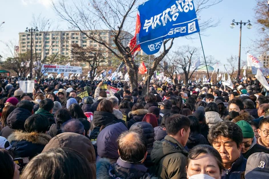 A large crowd of people protest in the streets.