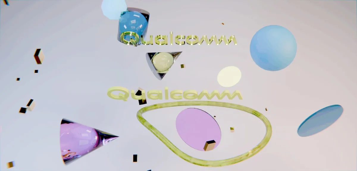 Colorful abstract shapes and scattered particles on a light surface.
