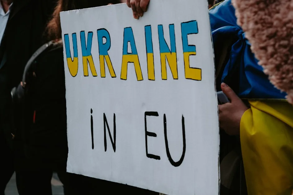 a person holding a sign that says ukraine in eu